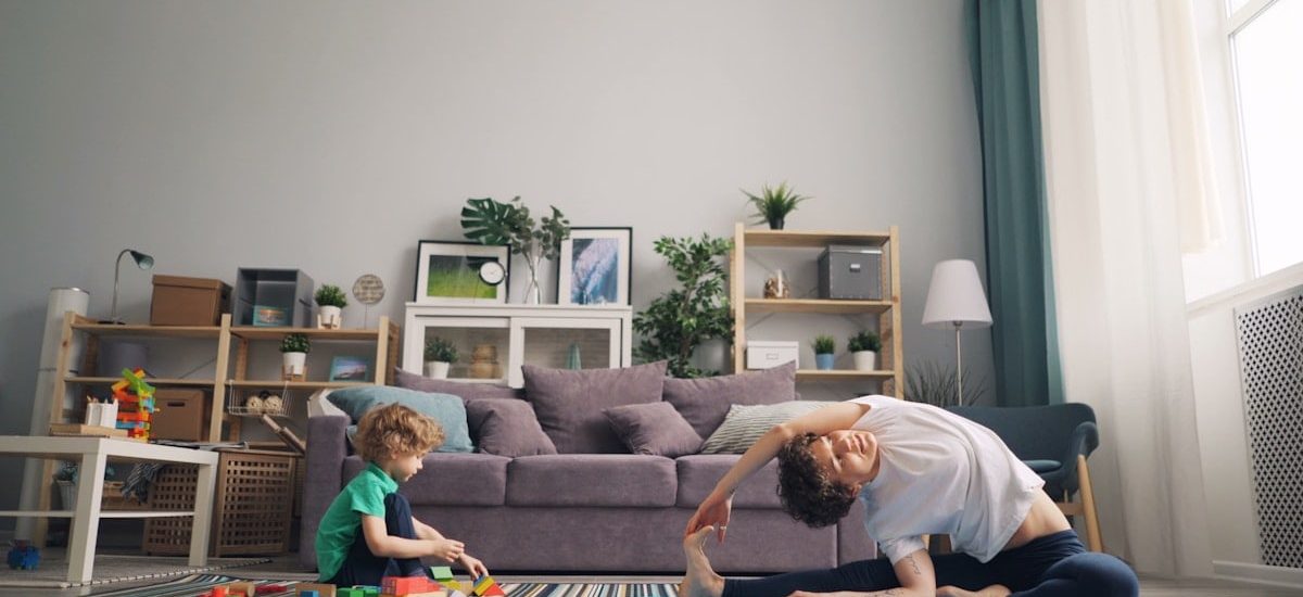 a man and a child playing on a rug in a living room