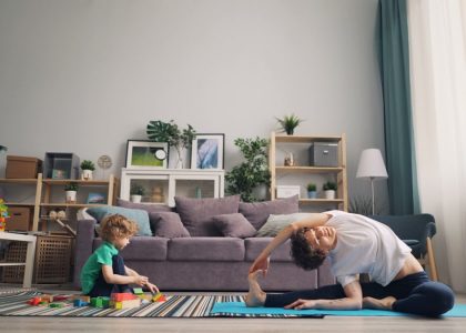 a man and a child playing on a rug in a living room